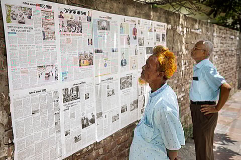 Newspapers pasted on a wall